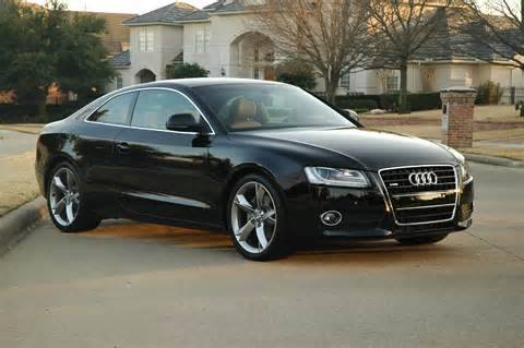 An upscale black car. The windscreen and windows are bulletproof and very dark tinted. It was another 18th birthday present from Malone.