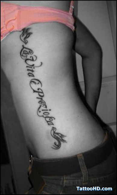 The words "La Vita Ã¨ Preziosa" (Life is Precious) down her right side with two doves before and after the phrase.