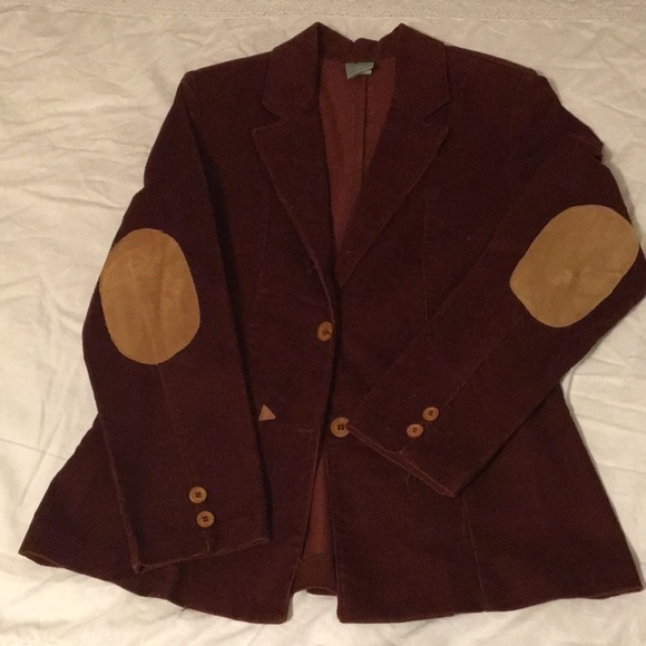 A well worn sport coat. It once belonged to his grandfather, a history professor. He usually has a flask, an emergency joint, and his glasses case in the pockets.