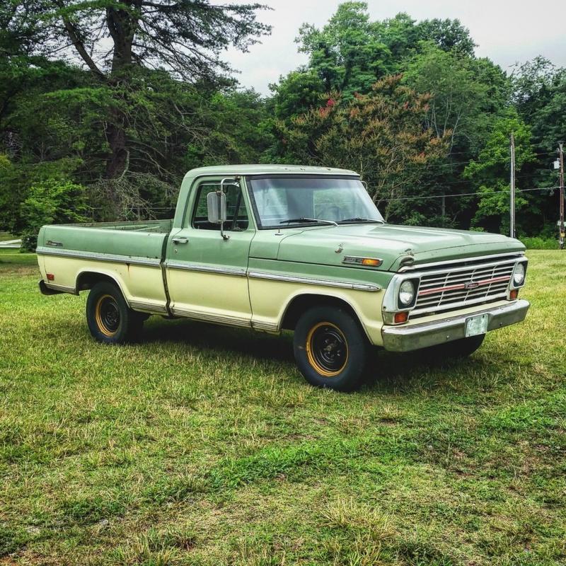 A 1960s ford. He sleeps in it using a camper shell on the bed.