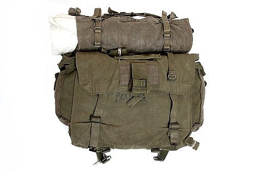 A canvas bag made by his mom and a standard bedroll.