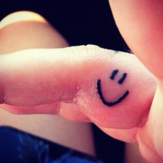Her smiley tattoo