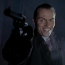 A man with a large and cruel grin pointing a pistol to the viewer's left.