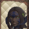 A portrait screenshot of Sali. While holding a cup of tea, he looks to the side and sneers in confusion.