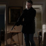 The Virtuoso with a pistol in both hands, quietly making his way through a house's living room.