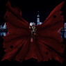 Covered head to toe in black, hovering in the air high above a city skyline at night. Red cloak billows for meters and meters and meters around her, making her look rather small in the center of it.