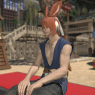 A screenshot of Fane sitting outside Kugane's teahouse. He smiles peacefully.
